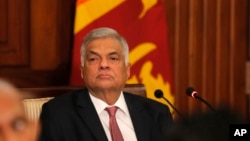 FILE - Then-Sri Lankan Prime Minister Ranil Wickremesinghe attends a meeting with media representatives and civil society members at his office in Colombo, Sri Lanka, Oct. 30, 2019. On Thursday, Wickremesinghe was reappointed to lead the country's governm