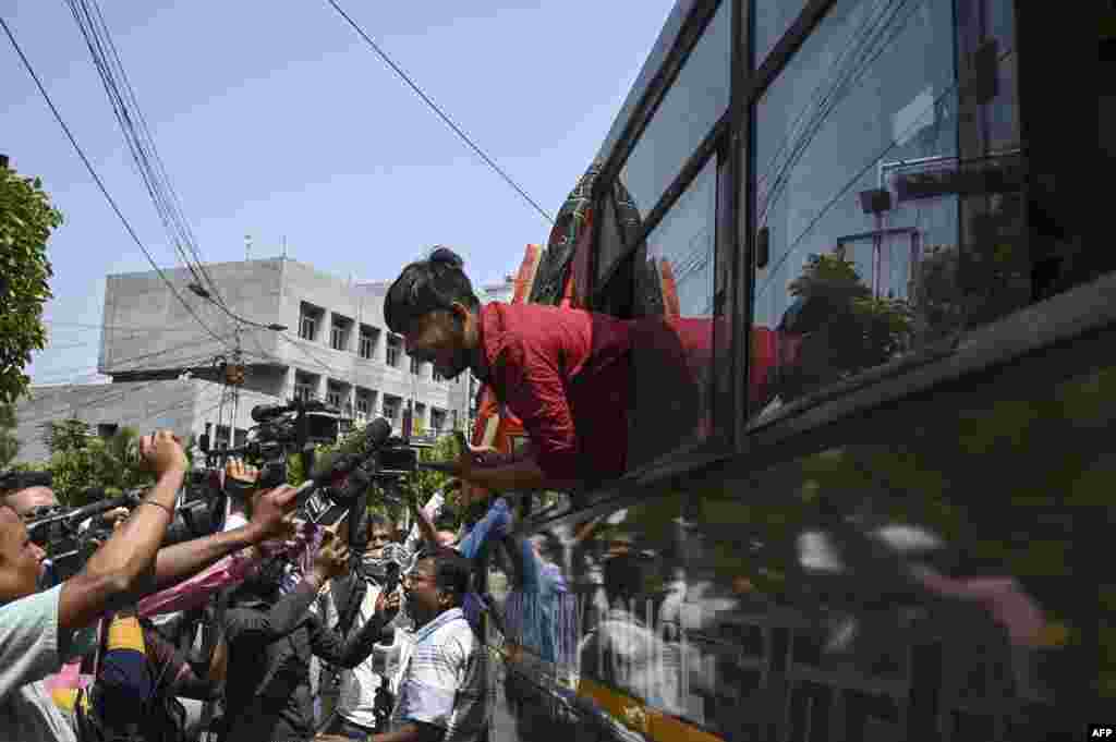 A Bharatiya Janata Party activist speaks to members of the press from a police vehicle after being detained during a protest against West Bengal&#39;s state government over alleged irregularities in the School Service Commission recruitment process, iin Kolkata, India.