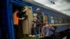 People fleeing from shelling board an evacuation train at the train station, in Pokrovsk, eastern Ukraine, Sunday, May 22, 2022. Civilians fleeing areas near the eastern front in the war in Ukraine Sunday described scenes of devastation as their towns an