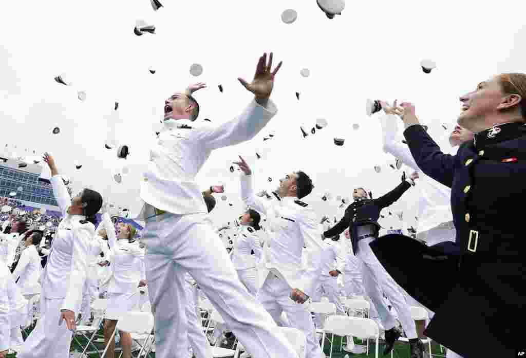 U.S. Naval Academy graduates celebrate and throw their covers at the end of the academy's graduation and commission ceremony in Annapolis, Maryland.