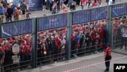 Liverpool fans stand outside, unable to get in on time, leading to the match being delayed prior to the UEFA Champions League Final football match between Liverpool and Real Madrid, at the Stade de France in Saint-Denis, north of Paris, May 28, 2022. 