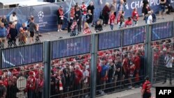 Liverpool fans stand outside, unable to get in on time, leading to the match being delayed prior to the UEFA Champions League Final football match between Liverpool and Real Madrid, at the Stade de France in Saint-Denis, north of Paris, May 28, 2022. 