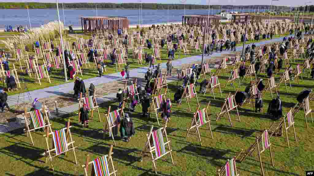 In this aerial view indigenous Mapuche women weave on a loom a one-kilomemter weave in an attempt to break a Guinness Record in Puerto Saavedra, Chile, May 21,2022.