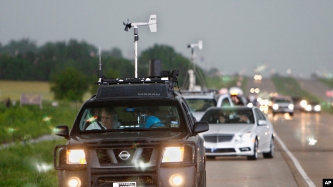 FILE - In this May 19, 2010 file photo taken near Kingfisher, Okla., storm chasers and spectator vehicles clog the road and shoulder of Highway 81.