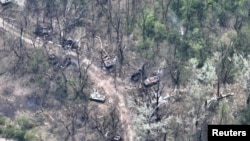This aerial view shows burned vehicles on the banks of Siversky Donets River, eastern Ukraine, in this handout image uploaded on May 12, 2022. (Ukrainian Airborne Forces Command/Reuters)