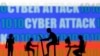 FILE - Figurines with computers and smartphones are seen in front of the words 'Cyber Attack', binary codes and the Russian flag, in this illustration taken Feb. 15, 2022. 