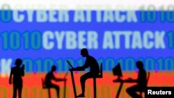 FILE - Figurines with computers and smartphones are seen in front of the words 'Cyber Attack', binary codes and the Russian flag, in this illustration taken Feb. 15, 2022. 