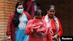 A family member of victims of the Tara Air passenger plane that crashed with 22 people on board while on its way to Jomsom cries as she walks out from the morgue in Kathmandu, Nepal, May 31, 2022. 