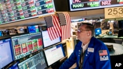 FILE - Trader Patrick King works the floor at the New York Stock Exchange, May 12, 2022, in New York.