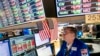 FILE - Trader Patrick King works the floor at the New York Stock Exchange, Thursday, May 12, 2022, in New York.