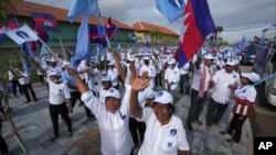 Cambodia's Candlelight Party supporters wave before marching during an election campaign for the June 5 communal elections in Phnom Penh, Cambodia, Saturday, May 21, 2022. (AP Photo/Heng Sinith)