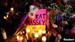 Candles and signs are left at a memorial for victims at the scene of a shooting at a Topps supermarket on May 16, 2022 in Buffalo, New York, US.