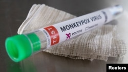 A test tube labeled "monkeypox virus positive" is seen in this illustration taken May 22, 2022. 