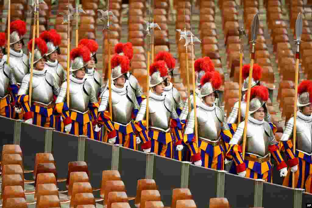 Vatican Swiss Guard members arrive at the Pope Paul VI hall on the occasion of their swearing-in ceremony, at the Vatican.