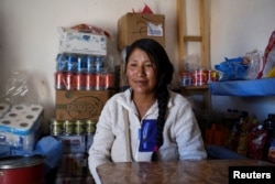 Karina Quispe sits in her store near the Salar de Uyuni in Uyuni, Bolivia March 29, 2022. (REUTERS/Claudia Morales)