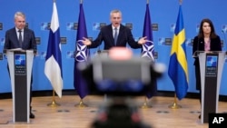 FILE - NATO Secretary General Jens Stoltenberg, center, speaks at a media conference with Finland's Foreign Minister Pekka Haavisto, left, and Sweden's Foreign Minister Ann Linde, at NATO headquarters in Brussels, Belgium Jan. 24, 2022.