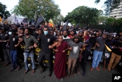 Anti-government protesters march near the president's official residence in Colombo, Sri Lanka, May 28, 2022.