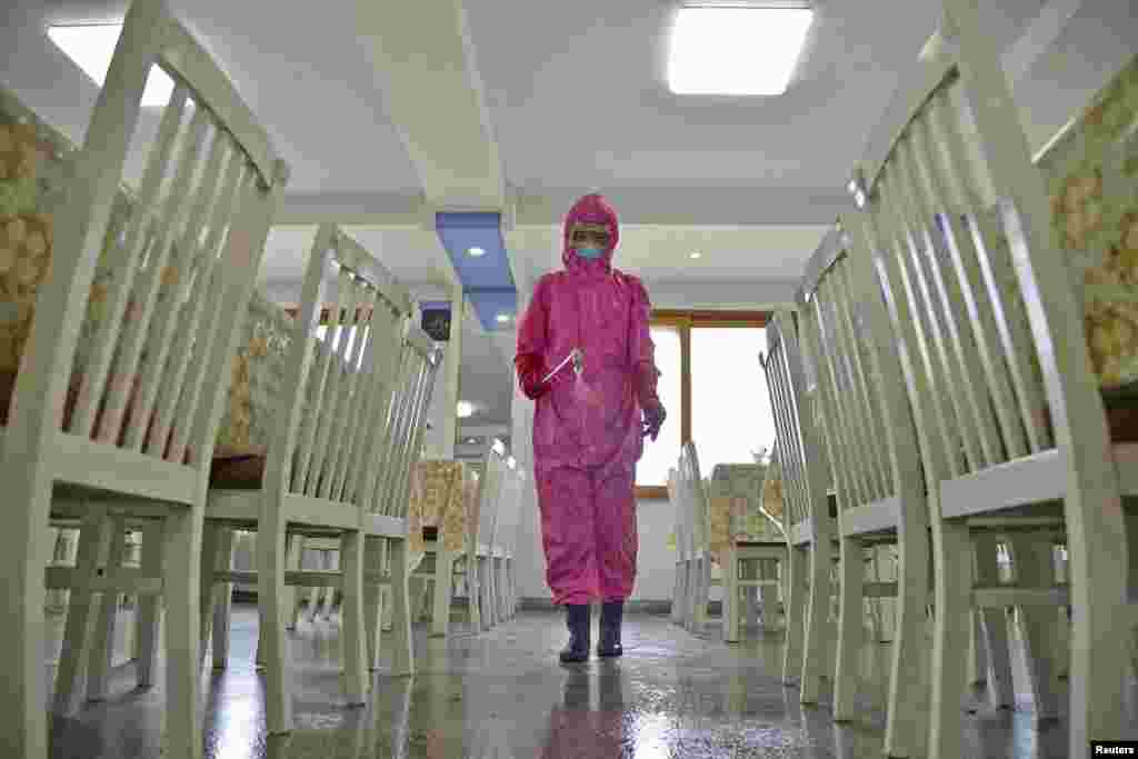 A worker disinfects a dining room at a sanitary supplies factory, amid growing fears over the spread of COVID-19, in Pyongyang, North Korea, in this photo taken by Kyodo on May 16, 2022, and released May 17, 2022.