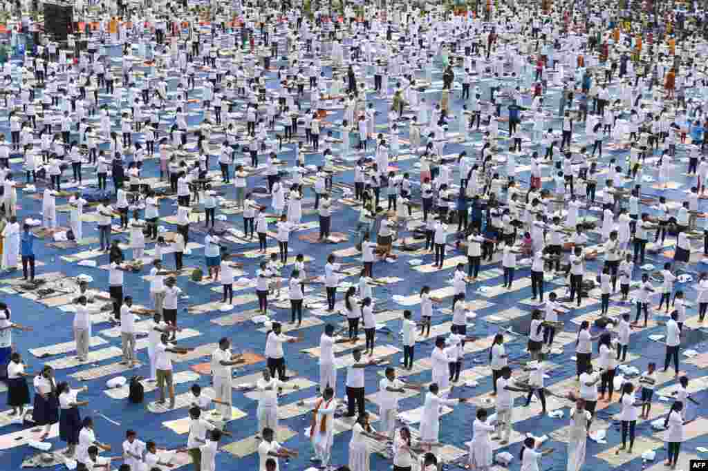 People participate in a mass yoga session at Lal Bahadur Shastri Stadium in Hyderabad.