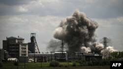 Smoke and dirt ascends after a strike at a factory in the city of Soledar at the eastern Ukranian region of Donbas on May 24, 2022, on the 90th day of the Russian invasion of Ukraine.
