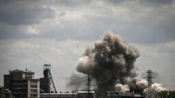 Smoke and dirt ascends after a strike at a factory in the city of Soledar at the eastern Ukranian region of Donbas on May 24, 2022, on the 90th day of the Russian invasion of Ukraine.