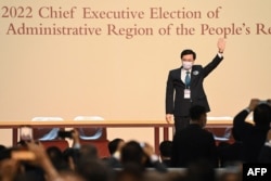 FILE - John Lee waves after becoming the city's new chief executive in Hong Kong, May 8, 2022.