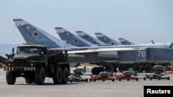 FILE - Russian military jets are seen at Hmeymim air base in Syria, June 18, 2016. 
