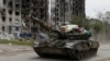 A Russian tank drives through the streets in the town of Popasna in the Luhansk Region, Ukraine, May 26, 2022. (REUTERS/Alexander Ermochenko)