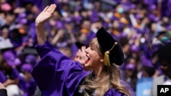 Taylor Swift waves to students at NYU's commencement on May 18, 2022. (AP Photo/Seth Wenig)