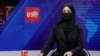 Khatereh Ahmadi a TV anchor, wears a face covering as she reads the news on TOLO NEWS, in Kabul, Afghanistan, May 22, 2022. 
