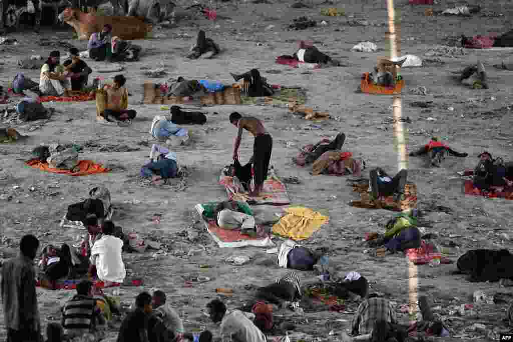 Homeless people rest under a bridge to escape the heat on a hot summer afternoon in New Delhi.