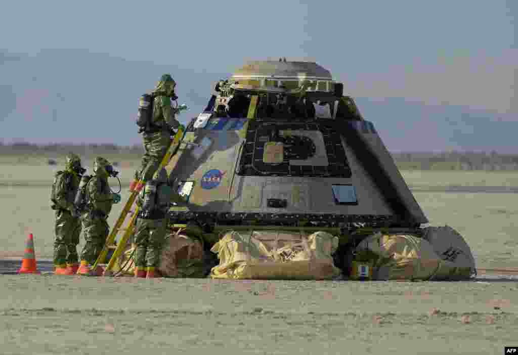 In this handout image courtesy of NASA, Boeing and NASA teams work around Boeing&#39;s CST-100 Starliner spacecraft after it landed at White Sands Missile Range&#39;s Space Harbor, May 25, 2022, in New Mexico.