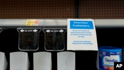 FILE - Shelves typically stocked with baby formula sit mostly empty at a store in San Antonio, May 10, 2022. 