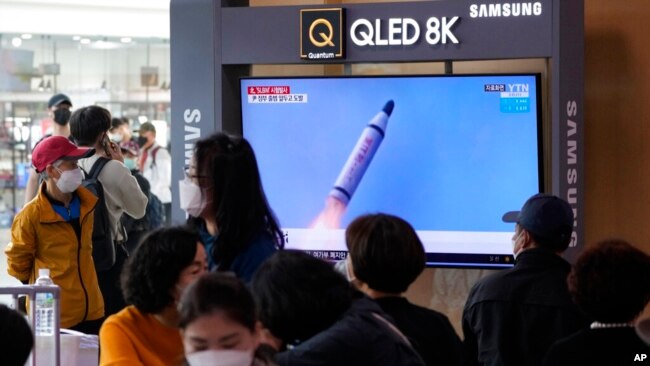 FILE - People watch a TV showing a file image of North Korea's missile launch during a news program at the Seoul Railway Station in Seoul, South Korea, May 7, 2022.