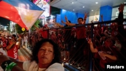 Supporters of Philippine president-elect Ferdinand 'Bongbong' Marcos Jr., son of late dictator Ferdinand Marcos, celebrate outside his headquarters in Mandaluyong City, Metro Manila, Philippines, May 11, 2022. 