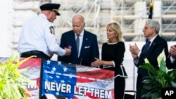 U.S. President Joe Biden, first lady Jill Biden and Attorney General Merrick Garland, right, attend the National Peace Officers' Memorial Service at the Capitol in Washington, May 15, 2022.