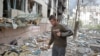 FILE - A local man walks on debris of a residential building damaged by a military strike, as Russia's attack on Ukraine continues, in Sievierodonetsk, Luhansk region, Ukraine. April 16, 2022. 