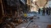 Ukrainian police officers document the destruction at one of Europe's largest clothing markets 'Barabashovo' (more than 75 hectares) in Kharkiv on May 16, 2022, which was destroyed as a result of shelling amid Russian invasion of Ukraine.