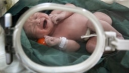 FILE - An Iranian newborn cries in an incubator at a hospital in Tehran, Dec. 5, 2006. When naming their children, Iran's government requires that families pick from among a list of approved monikers.