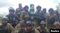 Ukrainian troops stand at the Ukraine-Russia border in what was said to be the Kharkiv region, Ukraine in this screen grab obtained from a video released on May 15, 2022. (Ukrainian Ministry of Defence/Handout via REUTERS)