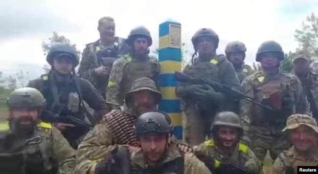 Ukrainian troops stand at the Ukraine-Russia border in what was said to be the Kharkiv region, Ukraine in this screen grab obtained from a video released on May 15, 2022. (Ukrainian Ministry of Defence/Handout via REUTERS)