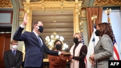 US Vice President Kamala Harris ceremonially swears in Mark Brzezinski to be Ambassador to Poland on January 19, 2022. Holding The Bible are daughter, Aurora Brzezinski, center, and and sister, Mika Brzezinski.