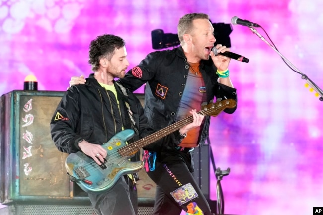 Guy Berryman, left, and Chris Martin of Coldplay performs during the band's Music of the Spheres world tour on Thursday, May 12, 2022, at State Farm Stadium in Glendale, Ariz. (Photo by Rick Scuteri/Invision/AP)