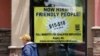 Starting wages are advertised on a sign in the window of a Taco Bell in Sacramento, Calif., May 9, 2022.