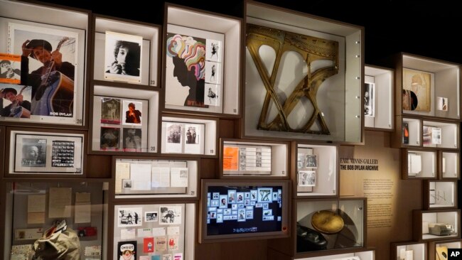 Artifacts are displayed on the archive wall at the Bob Dylan Center, May 5, 2022, in Tulsa, Okla.