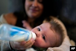 Ashley Maddox feeds her 5-month-old son, Cole, with formula she bought through a Facebook group of mothers in need on May 12, 2022, in Imperial Beach, Calif. Unable to get formula in stores, parents such as Maddox have obtained formula in non-traditional ways during the shortage.