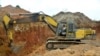 FILE - In this photograph taken on April 4, 2018, a Chinese employee of a mining company operates a machine at a mining site in the Cameroon town of Betare Oya.