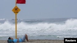 A man rests on a beach as Hurricane Agatha barrels toward the southern coast of Mexico, in Puerto Escondido in Oaxaca state, Mexico, May 29, 2022.