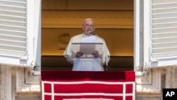 Pope Francis delivers his blessing as he recites the Regina Coeli noon prayer from the window of his studio overlooking St. Peter's Square, at the Vatican, May 22, 2022.