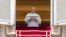 Pope Francis delivers his blessing as he recites the Regina Coeli noon prayer from the window of his studio overlooking St. Peter's Square, at the Vatican, May 22, 2022.